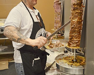 Katie Rickman | The Vindicator.Dino Diamantis of Campbell cuts meat off of a skewer to prepare a traditional gyro called Souvlaki during the first night of the Greek Festival at Archangel Michael Greek Orthodox Church in Campbell on Friday, Feb. 13, 2015.