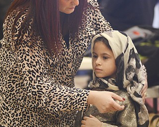 Katie Rickman | The Vindicator.Noula Pizanias of Campbell fixes the babushka  of seven-year-old Gianna Rotunno, also of Campbell, prior to the traditional dance performed by several children and young adults during the first night of the Greek Festival at Archangel Michael Greek Orthodox Church in Campbell on Friday, Feb. 13, 2015.