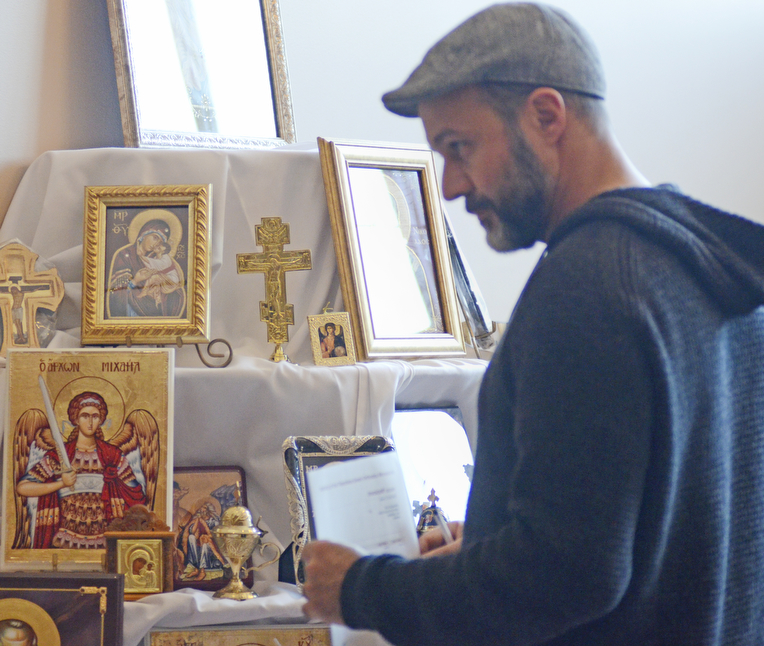 Katie Rickman | The Vindicator.Nick Capuzello of Campbell looks at artwork featuring several religious figures for sale during the first night of the Greek Festival at Archangel Michael Greek Orthodox Church in Campbell on Friday, Feb. 13, 2015.