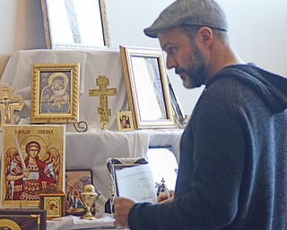 Katie Rickman | The Vindicator.Nick Capuzello of Campbell looks at artwork featuring several religious figures for sale during the first night of the Greek Festival at Archangel Michael Greek Orthodox Church in Campbell on Friday, Feb. 13, 2015.