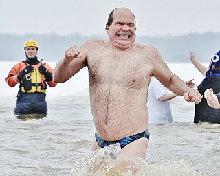 Jeff Lange | The Vindicator  Tom Hrdy also known as Speedo Man of Garrettsville grits his teeth as he sprints out of the icy waters of Mosquito Lake during Saturday afternoon's Polar Plunge.