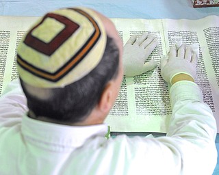 Jeff Lange | The Vindicator  Ron Sabelli of Boardman cleans one of the Torahs Sunday afternoon at Congregation Ohev Tzedek.