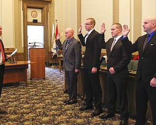        ROBERT K. YOSAY  | THE VINDICATOR..the four new police officers sworn onto the force Monday, three have previous experience while the fourth served five years in military..Sworn in by Mayor John McNally were Brandon Caraway, 26, of McDonald; Mark Sember, 23, of Howland; Jeffrey Savnik, 27, of Youngstown; and Chase Lemke, 24, of Austintown..