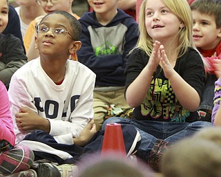 William D. Lewis the Vindicator  Champion Elementary School 1rst graders Landon Primus, left, and Jaidah Gross listen during a preswentation at their school Monday 1-26-14 by the Harlem Globetrotters.
