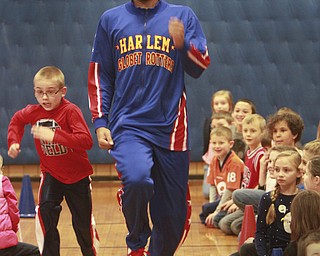William D Lewis The Vindicator Harlem Globetrotter Zues McClurkin, a native of Columbus, Ohio, races Champion elem school 2nd grader Ethan Laslo Monday 1-26-15 during a presentation at the school. The trotters will b at the Covelli Thursday night..