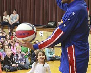 William D Lewis The Vindicator Harlem Globetrotter Zues McClurkin, a native of Columbus, Ohio, tdoes basketball tricks during a 1-26-15 presentation at their school. The trotters will be at the Covelli Thursday night.