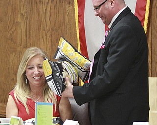 William D. Lewis the vindicator Austintown Twp trustee Lisa Oles as fellow trustee Jim davis presents her with a bag of popcorn during a 1-26-15 trustees meeting. She is resigning this was her last meeting. Many citizens , politicians and civic groups were on hand to see her off..
