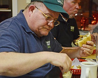 Katie Rickman | The Vindicator.John Spatar, on left, and Scott Long eat food during the Burger Guyz visit to the Courthouse Grill in Warren on Wednesday, Jan. 28, 2015.