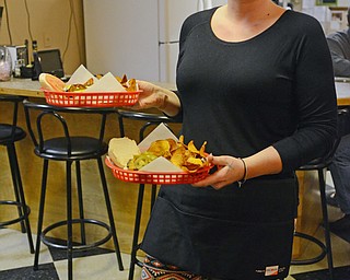Katie Rickman | The Vindicator.Katie Badanjek of Southington delivers burgers to the Burger Guys during their visit to the Courthouse Grill in Warren on Wednesday, Jan. 28, 2015.