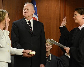 Katie Rickman | The Vindicator.The Honorable Sharon L. Kennedy administers the Oath of Office to Judge Carol Ann Robb as her husband Kenneth Robb holds the bible on Wednesday, Jan. 28, 2015.