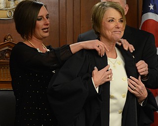 Katie Rickman | The Vindicator.Monica Robb and Kenneth Robb help Judge Carol Ann Robb with her robe after she took Oath of Office at the Seventh District of Appeals in Youngstown Wednesday, Jan. 28, 2015.