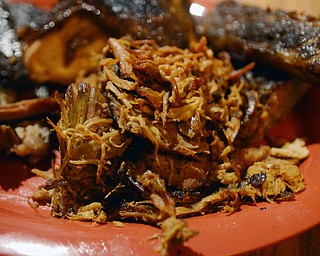 Katie Rickman | The Vindicator.Brother in Food writers  Mike Vallas and Mark Smesko visited the Fire Grill in Girard on Thursday, Jan. 29, 2015. Featured here are their signature combo platter ÒCampire ComboÓ, in center is pulled pork.