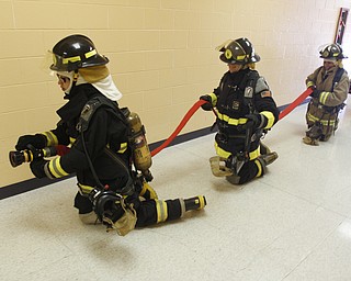        ROBERT K. YOSAY  | THE VINDICATOR.. Cadets learn to duck walk or crawl to the fire.. because smoke and less oxygen up high..A new program at Choffin Career and Technical Center teaches students fire fighting skills and techniques while aiming to increase the number of Youngstown residents in the fire department ranks..