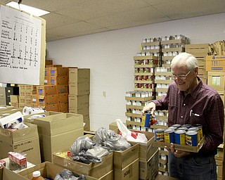 William D. Lewis  The Vindicator   Jeter Coggins of Liberty volunteers at a food give away at Pleasant Valley Church in Liberty. He is shown sorting food stuffs.
