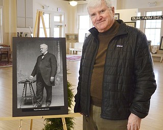 Katie Rickman | The Vindicator.Tom Kuster poses next to a portrait of Frank H. Buhl that is on display with many other vintage artifacts from Buhl Farm Park and the Buhl family legacy.