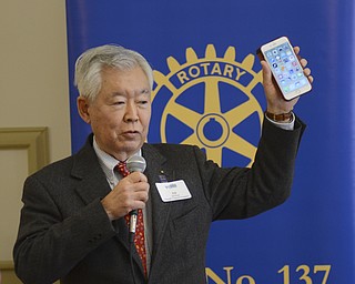 Katie Rickman | The Vindicator.Ed Futa, past Rotary General Secretary holds up an iPhone and says that like an app that makes the phone actually a smart phone, the rotary also does the same for the community. He speaks a the noon luncheon at The Tyler Mahoning Valley History Center Friday, Jan. 30, 2015.
