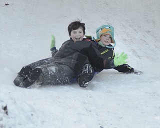 Katie Rickman | The Vindicator.Brandon Sztary 9 of Austintown, on left, and Ethan Bishop 9 of Youngstown share a sled ride down a hill at Mill Creek MetroParks on Saturday, Jan. 31, 2015. Dozens of local families spent time enjoying the cold weather while sledding at various locations around the park.