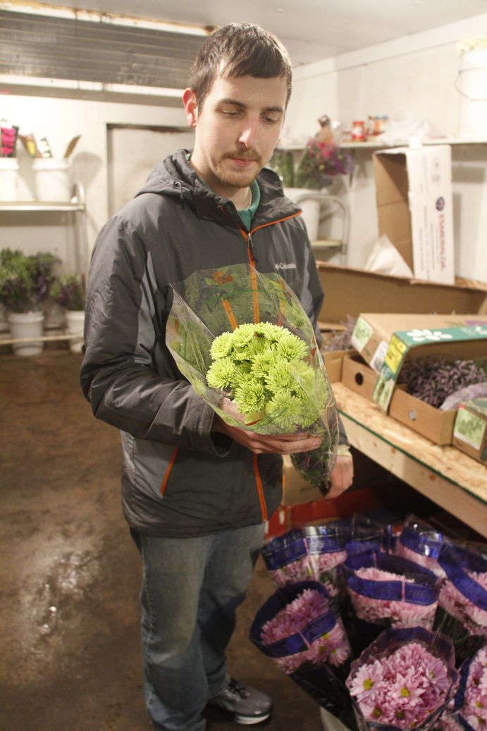        ROBERT K. YOSAY  | THE VINDICATOR..Columbiana Wholesale Floral -which is Wholesale Florists, Florist Supply Wholesalers & Manufacturers, Florists Supplies - as Jim Drotleff  prepares some flowers for shipping.