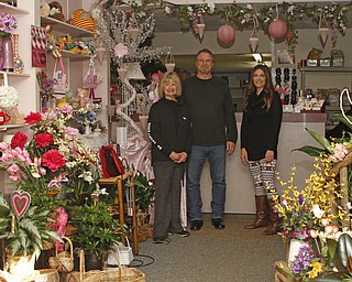 Sweet Arrangements owners, Maryann Sayavich (left) and Joe Mozzy (middle) pose for a picture with manager Jennifer Sayavich in the lobby of Sweet Arrangements florists in Youngstown on Saturday morning.   Dustin Livesay  |  The Vindicator  1/31/15  Sweet Arrangements, Youngstown.