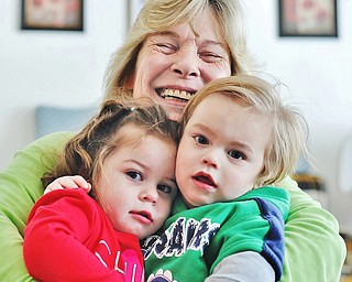 Jeff Lange | The Vindicator  Betty Strauderman smiles as she wraps Serenity White (left) age 19 months and Gavin Strauderman (right) age 19 months in her home in Warren, Tuesday, January 27th.