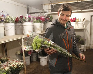        ROBERT K. YOSAY  | THE VINDICATOR..Columbiana Wholesale Floral -which is Wholesale Florists, Florist Supply Wholesalers & Manufacturers, Florists Supplies - as Jim Drotleff  prepares some flowers for shipping.