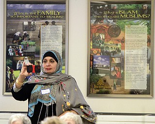 William D. Lewis The Vindicator Ayda Abuasi takes a video with her phone during 69th annual Interfaith Tea held Tuesday 2-3-15 at the Islamic Society of Youngsotwn's mosque.
