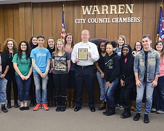 Warren Chief of Police Eric Merkel, center, with Warren G. Harding students who are in the school’s Key Club and involved in student council. About 30 students provided breakfast, lunch, a plaque and other gifts of appreciation Thursday to the city police department.