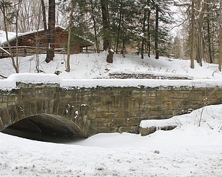        ROBERT K. YOSAY  | THE VINDICATOR..The bridge nearest Lilly Pond  with Birch Hill Cabin in the backround the bridge will be repointed -two historic stone arch bridges in the park. The project, set to begin this summer, is a rehabilitation of Orchard Meadow and Rogers bridges, both of which extend over Bear Creek. The plan is to clean and re-point the bridgesÕ stone masonry, construct retaining curbs and replace the pavement