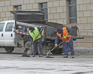        ROBERT K. YOSAY  | THE VINDICATOR..Pot Hole Season came early as hard freezes combined with thaws have got area roads.. full of the driving hazards ..Youngstown city Crews.. try their best to keep up with the potholes as they work on  coldpatch at Market and Front in Southbound lanes . .-30-