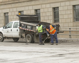        ROBERT K. YOSAY  | THE VINDICATOR..Pot Hole Season came early as hard freezes combined with thaws have got area roads.. full of the driving hazards ..Youngstown city Crews.. try their best to keep up with the potholes as they work on  coldpatch at Market and Front in Southbound lanes . .-30-