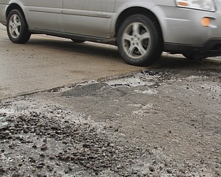        ROBERT K. YOSAY  | THE VINDICATOR..Pot Hole Season came early as hard freezes combined with thaws have got area roads.. full of the driving hazards .. On New Rd over Rt. 11  the pavement has heaved so not only do you get to dodge a pot hole but the whole bridge deck is below the pavement of the road by several inches....-30-