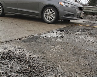        ROBERT K. YOSAY  | THE VINDICATOR..Pot Hole Season came early as hard freezes combined with thaws have got area roads.. full of the driving hazards .. On New Rd over Rt. 11  the pavement has heaved so not only do you get to dodge a pot hole but the whole bridge deck is below the pavement of the road by several inches....-30-