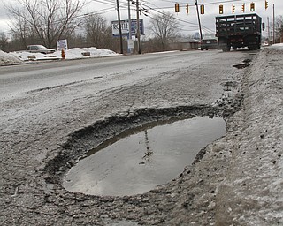        ROBERT K. YOSAY  | THE VINDICATOR..Pot Hole Season came early as hard freezes combined with thaws have got area roads.. full of the driving hazards ..this is on Meridian Rd. near Vestal .-30-