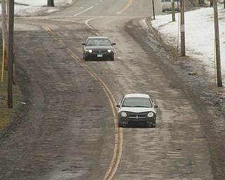        ROBERT K. YOSAY  | THE VINDICATOR..Pot Hole Season came early as hard freezes combined with thaws have got area roads.. full of the driving hazards ..On Eastbound MLK near  Rayen Ave . Motorists drive left of center to stay out of the minefield of pot holes.. .-30-