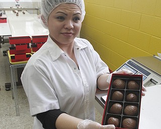        ROBERT K. YOSAY  | THE VINDICATOR..Gorant Choclatier    Carolyn Wright  shows off a box of the delicious morsels of chocolate coveres strawberries. the chocolate at the factory on Market Street.. . .-30-