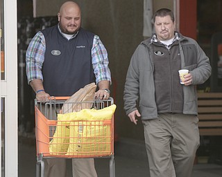        ROBERT K. YOSAY  | THE VINDICATOR..Nick Corlett -  Jason Habarka ..  head out  of depot - salt in hand..The yellow bags of rock salt steadily started to diminish from their palettes at the Home Depot in Austintown in the early afternoon on Tuesday.. A salt shortage had customers taking bag after bag of the ice melting salt... .-30-