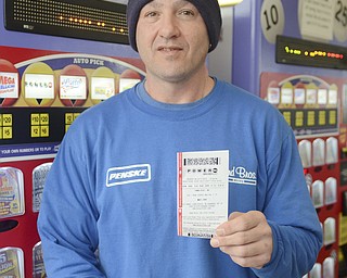 Katie Rickman | The Vindicator.Willie McCallister of Salem holds up his lottery ticket for the $500 million Powerball lottery on Wednesday, Feb. 11, 2015.