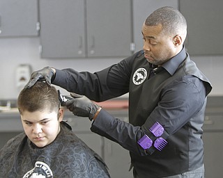        ROBERT K. YOSAY  | THE VINDICATOR..working on his 'fade' is Kelan Bilal of Excalibur  Barber grooming Lounge.... the student is  Nisael Cupelas 7th grade.Students at Volney Rogers Discovery Program had two local barbers came in to the school today ( wed) and cut and  styled over 30 students ( boys) just in time for picture day and Character Court where students in the 8th grade are elected as tops in their class - to be held Thursday at 1 PM- Character day will also include performances by after school activites of Dance Fitness, D.J./s and Media shows.