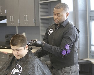        ROBERT K. YOSAY  | THE VINDICATOR..working on his 'fade' is Kelan Bilal of Excalibur  Barber grooming Lounge.... the student is  Nisael Cupelas 7th grade.Students at Volney Rogers Discovery Program had two local barbers came in to the school today ( wed) and cut and  styled over 30 students ( boys) just in time for picture day and Character Court where students in the 8th grade are elected as tops in their class - to be held Thursday at 1 PM- Character day will also include performances by after school activites of Dance Fitness, D.J./s and Media shows.