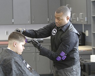        ROBERT K. YOSAY  | THE VINDICATOR..working on his 'fade' is Kelan Bilal of Excalibur  Barber grooming Lounge.... the student is  Nisael Cupelas 7th grade.Students at Volney Rogers Discovery Program had two local barbers came in to the school today ( wed) and cut and  styled over 30 students ( boys) just in time for picture day and Character Court where students in the 8th grade are elected as tops in their class - to be held Thursday at 1 PM- Character day will also include performances by after school activites of Dance Fitness, D.J./s and Media shows.