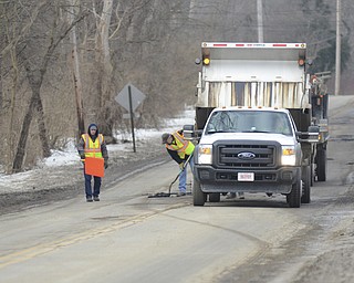 Katie Rickman | The Vindicator.Road crews work on patching pot holes on Truesdale Rd. in Youngstown on Wednesday, Feb. 11, 2015.