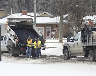 Katie Rickman | The Vindicator.Road crews work on patching pot holes on Truesdale Rd. in Youngstown on Wednesday, Feb. 11, 2015.