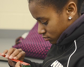 Katie Rickman | The Vindicator.Rayonna Booth 16 of Youngstown measures a Rasberry Pi to enter the numbers into a computer system in order to design a case for it on Feb. 12, 2015 at Chaney High School.