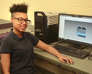 Katie Rickman | The Vindicator.Teana Sullivan 16, of Youngstown smiles next to a computer screen which displays the Polaroid style camera she is designing in a computer club at Chaney High School on Thursday, Feb. 12, 2015.