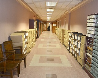Katie Rickman | The Vindicator.The microfilm department at the Mahoning County Courthouse is in the process of sorting various documents and microfilming them on Thursday, Feb. 12, 2015. Boxes and filled with files line the basement hallway where the microfilm department is located.