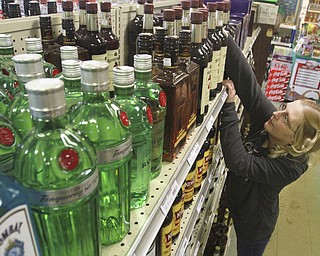 William D Lewis the vindicator Lisa Lippiatt, employee at Town Center Liquor in girard checks stock at the store 2-12-15.
