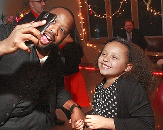 William D. Lewis the VindicatorJulius sims of Youngstown snaps a photyo as he and his daughter Layla Sims, 9, dance during a Daddy Daughter Valentine event at Boardman Park Thursday 2-12-15.