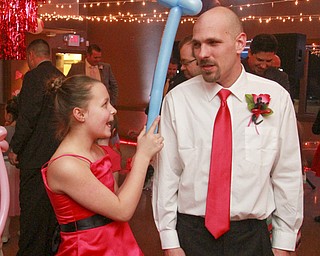 William D. Lewis the Vindicator Haylie Stilson, 10, taps her dad James Marotti on hte headwith a balloon during a Daddy Daughter Valentine event at Boardman Park Thursday 2-12-15. They are from Boardman.