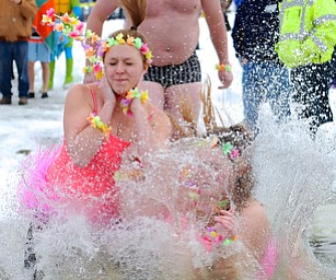 Jeff Lange | The Vindicator  Lauren Learn of Austintown .(left) jumps into the freezing waters of Lake Milton with her cousin Amanda Learn during Saturday's Cure Polar Bear Plunge in Lake Milton.