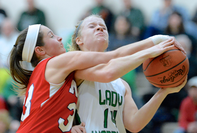 Jeff Lange | The Vindicator  Melinda Trimmer (14) of West Branch goes to the basket for two under Niles' Alexis Petrich in the first half of their Monday-night matchup at West Branch High School.